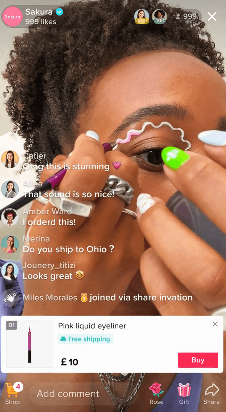 Dropshipping marketing strategies: A person applies pink liquid eyeliner in a wavy line above their eyebrow during a live online shopping stream. User comments and product details, including price and free shipping, are visible on the screen.